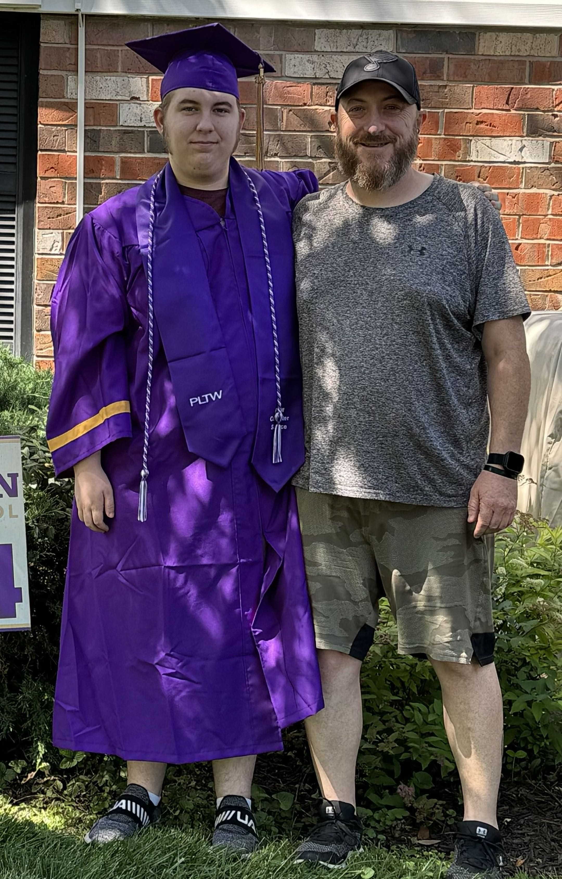 Wearing the cap & gown with my father